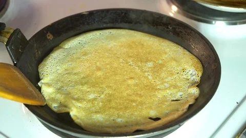 The chef takes a pancake in a frying pan Stock Footage 85951679