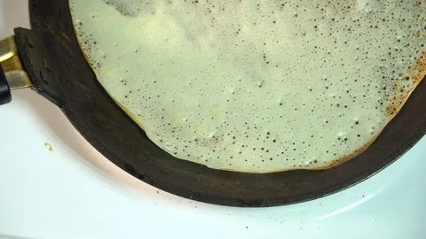The chef takes a pancake in a frying pan Stock Footage 85951685