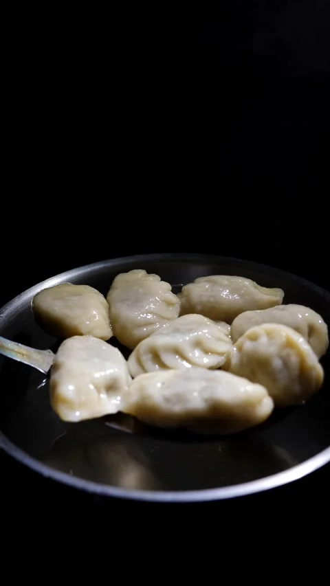 Chef takes ready dumplings from the pan. slow motion, Restaurant menu Stock Footage 310754807