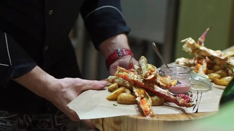 The chef takes the red crayfish on a large wooden platter. Delicious tentacles Stock Footage 77361005