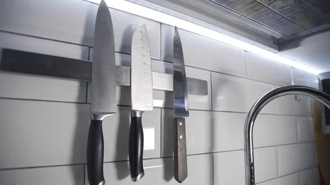 Chef takes sharp knife before cooking, kitchen stuff, steel knife, cooking the Stock Footage 76916471