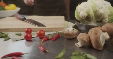 Chef takes sharp steel knife from the table. 4K Slow Motion Stock Footage 123100133