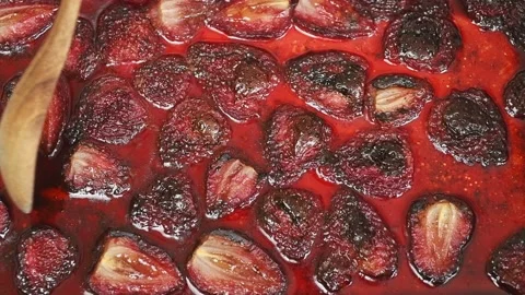 The chef takes some of the strawberry jam with a spoon. Stock Footage 207021845
