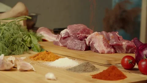 The chef takes the spices in his hand and sprinkles the meat Stock Footage 156287953