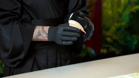 Chef taking rice and making a ball in hands in small traditional sushi Stockbeeldmateriaal 239096446