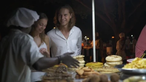 Chef talking to the tourists about various foods arranged in the stall Video stock 85894195