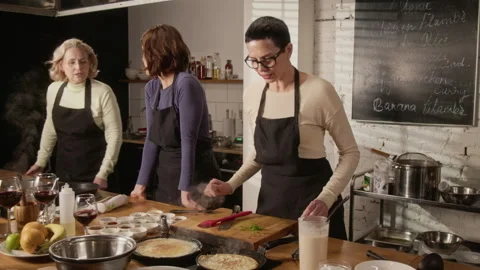 Chef Teaching Group of Three Women How to Cook Crepes at Master Class Stock Footage 332575885