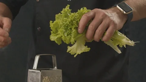 Chef is tearing his hands green fresh salad. Slow motion video Stock Footage 112286536