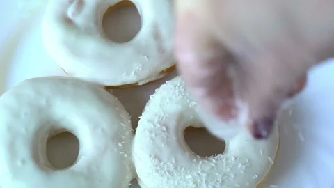 Chef technologist decorates some freshly made and oily doughnuts with white colo Stock Footage 199489244