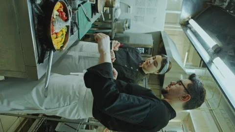 Chef Telling How to Cook Dish to Female Apprentice Taking Notes in Kitchen Stock Footage 270140331