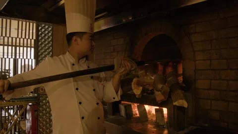 Chef Tending Wood-Fired Oven in Beijing Restaurant Kitchen Preparing Food Stock Footage 345788086