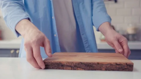The chef is throwing the board in the air over the kitchen table. Stock Footage 130989978