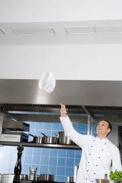 A chef throwing his hat into the air Stock Photos
