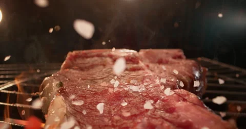 Chef throwing salt on meat steak Stock Footage 311831873