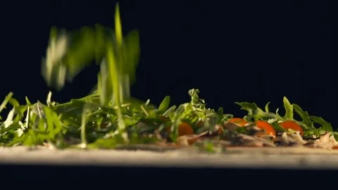 The chef throws a arugula on a pizza. Slow Motion Stock Footage 74493464