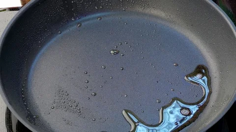 Chef throws chopped sausage in a frying pan Stock Footage 84554921