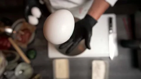 Chef throws an egg in  air Stock Footage 168231811