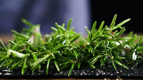 Chef throws fresh rosemary on cutting board, slow motion. Video stock 125528475