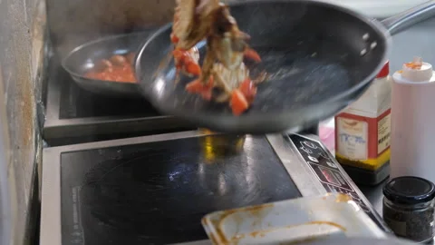 Chef throws up frying mix of vegetables and tofu Stock Footage 200078526