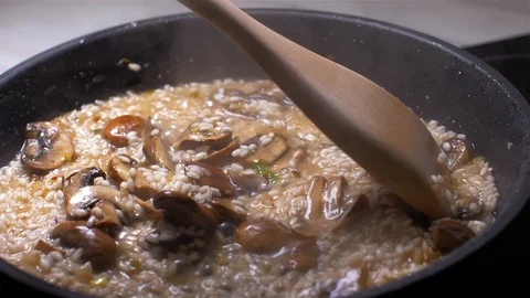 Chef throws the risotto with mushrooms in a pan 動画素材 103631495