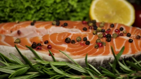 Chef throws sprigs of rosemary on salmon steaks, slow motion. Concept of healthy Stock Footage 211871501