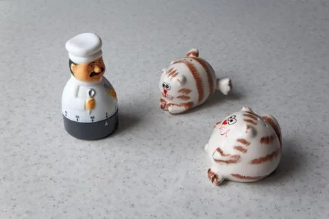 Chef Timer plays with fat salt shakers Stock Photos