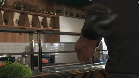 Chef tosses and catches a large knife in his kitchen Stock Footage 255931985
