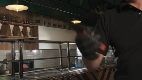 Chef tosses and catches a large knife in his kitchen Stock Footage 270725385