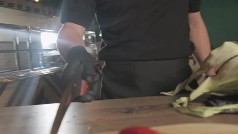 Chef tosses and catches a large knife in his kitchen Stock Footage 310382239