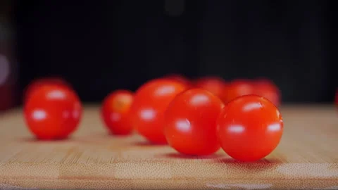 Chef Tosses Cherry Tomatoes onto Cutting Board as They Scatter. Stock-Footage 346861657