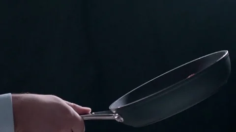Chef tosses fried bacon on the hot pan in slow motion, cooking meat, meals with Stock Footage 86786800