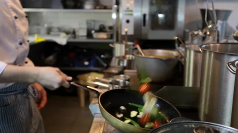 Chef tosses a pan fried vegetables Stock Footage 44230802