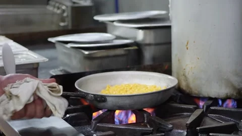 Chef tossing and cooking corn on high heat gas stove 库存影片 203897278