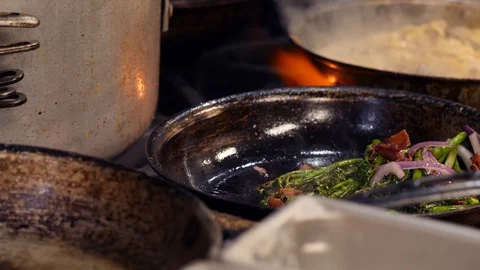 Chef tossing pan while frying mixed vegetables Stock Footage 127601799