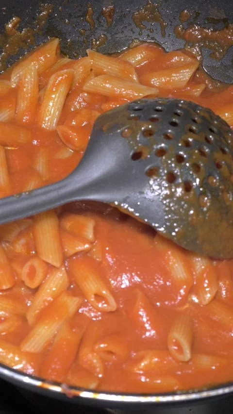 Chef Tossing Pasta With Tomato Sauce in a Pan, Restaurant Kitchen Video stock 336793802
