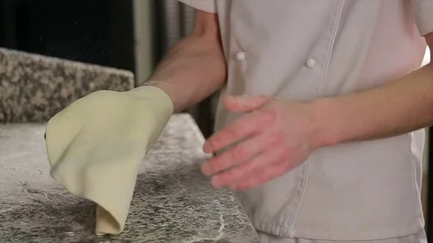 Chef Tossing Pizza Dough. Skillful chef preparing a pizza Stock Footage 72984739