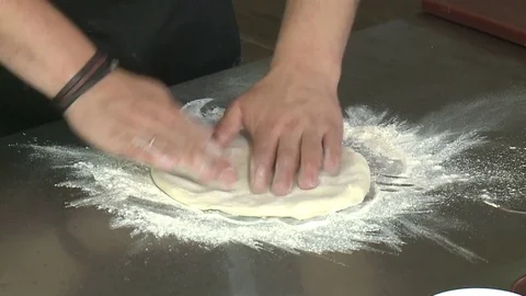 Chef Tossing Pizza Dough. Skillful chef preparing a pizza Stock Footage 80266505