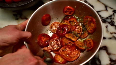 Chef Tossing Roasted Tomatoes with Herbs in a Bowl Stock Footage 328705910