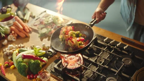 Chef tossing sliced vegetables in pan Stock Footage 311835046