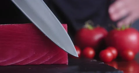 Chef touches fresh piece of raw tuna with sharp knife. Japanese restaurant Stock Footage 148765839