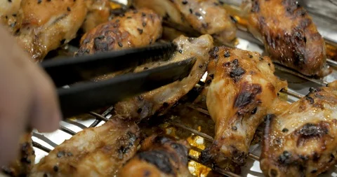 Chef turn chicken wings to the other sides for grilling Stock Footage 99953312