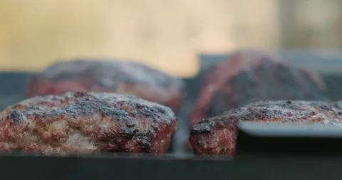 Chef Turn over One of Four Almost Cooked Cutlets by Culinary Tongs on Other Side Stock Footage 132982849