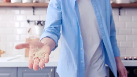 The chef is turning around and throwing coarse rice into the lens. Stock Footage 130990957