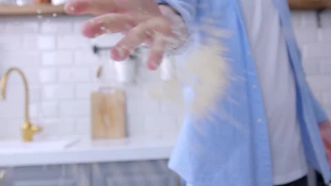 The chef is turning around and throwing coarse rice into the lens. Stock Footage 134232075