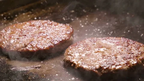 Chef turning over beef or pork cutlets frying on grill. Slow motion. HD Stock Footage 86324114