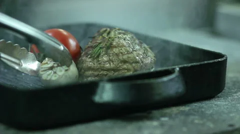 Chef turning  steaks and vegetables on hot grill Stock Footage 61850930
