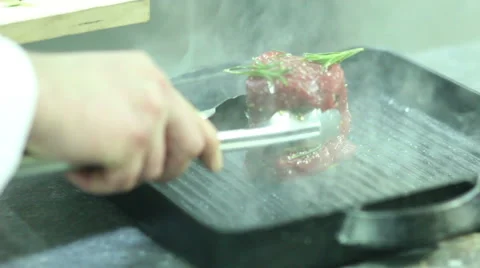 Chef turning  steaks on grill pan Stock Footage 61851820