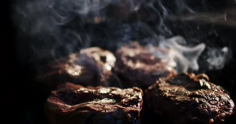 Chef Turning Thick Beef Steaks with Tongs on Barbecue Grill, Smoky Close Up Stock Footage 340321661