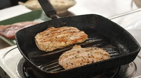 Chef turning thick juicy rib-eye steaks on hot grill Stock-Footage 64230718