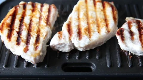 The chef turns the grilled meat over on the grill. Stock Footage 152770066